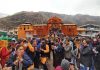 Devotees in traditional attire waiting in queue for their turn to offer prayer to Lord Badrinath on the opening of the doors of Badrinath Dham on Thursday. (UNI)