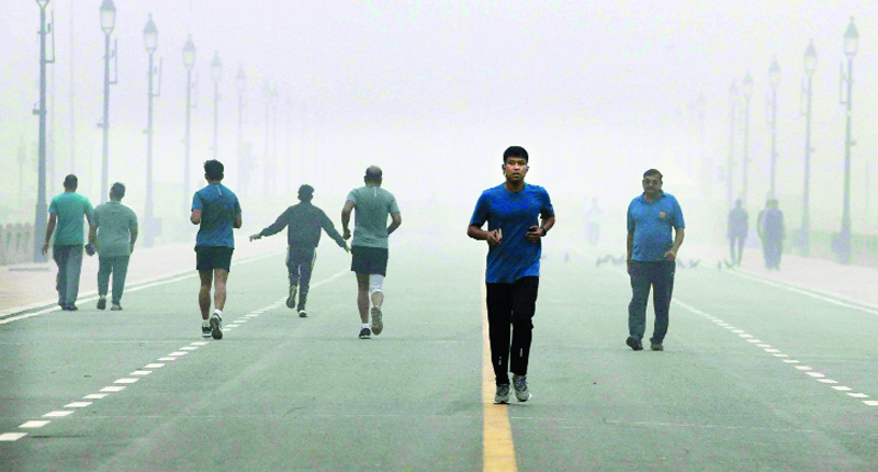 People jogging at Kartavya path as shallow fog engulfs, unusual for May which is the hottest month of the year in the city, in New Delhi on Thursday. (UNI) People jogging at Kartavya path as shallow fog engulfs, unusual for May which is the hottest month of the year in the city, in New Delhi on Thursday. (UNI)