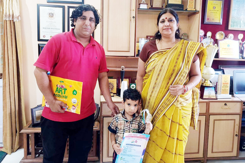 DPS Jammu student Kyra Thakyal (Prep-C) posing with Principal Ruchi Chabra and teacher Suresh Kumar.