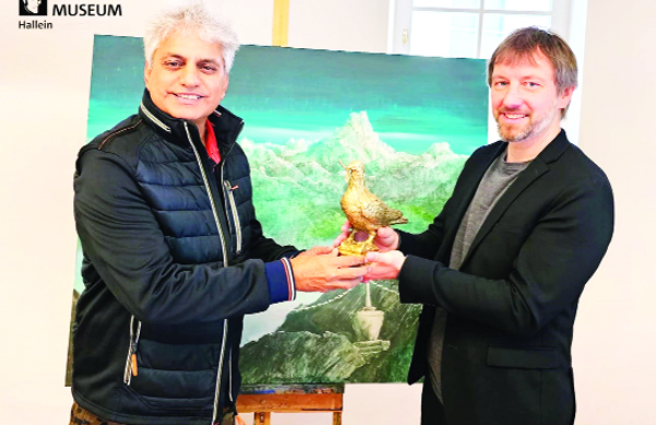 Mag Florian Knopp, Manager of the Silent Night Museum Hallein presenting the peace dove GruberTaube to K K Gandhi. Mag Florian Knopp, Manager of the Silent Night Museum Hallein presenting the peace dove GruberTaube to K K Gandhi.