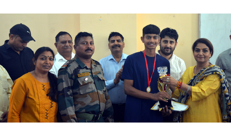 A winner being awarded with a trophy at Kathua Campus Jammu University on Thursday. A winner being awarded with a trophy at Kathua Campus Jammu University on Thursday.