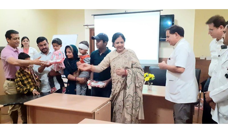 Principal GMC Jammu Dr Shashi Sudhan Sharma presenting gifts to survivors in PICU of SMGS Hospital, Jammu.