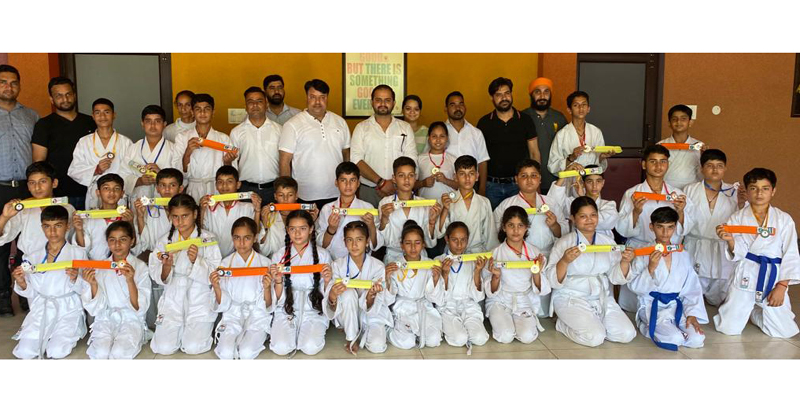 Karate players posing for a group photograph during belt grading test at Rajouri. Karate players posing for a group photograph during belt grading test at Rajouri.