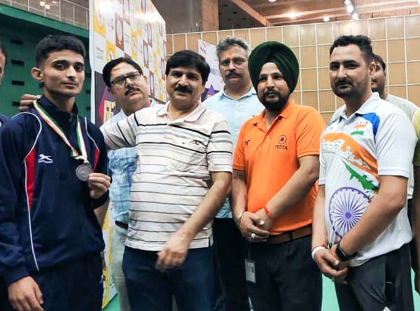 Director, Department of Youth Services and Sports, Subash Chander Chibber and Coaching Staff posing for a group photograph with bronze medal winner Toseef Tahir at Delhi. Director, Department of Youth Services and Sports, Subash Chander Chibber and Coaching Staff posing for a group photograph with bronze medal winner Toseef Tahir at Delhi.