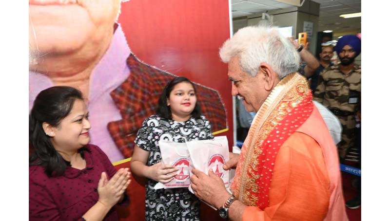 LG Manoj Sinha distributing Prasad packages to the people at Jammu Airport. LG Manoj Sinha distributing Prasad packages to the people at Jammu Airport.