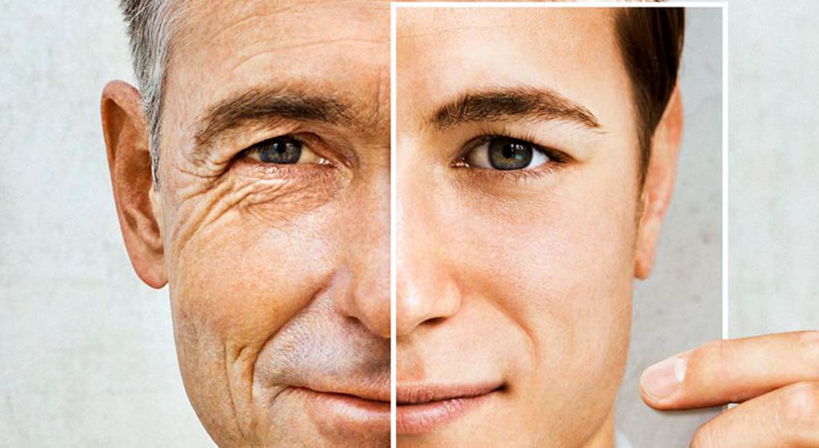 ManIn50sHoldsUpPhotoOfYoungerSelfAgainstHalfOfFace_1024