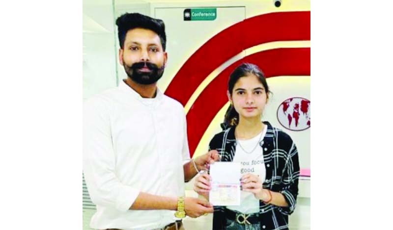 A minor student aspiring to study abroad posing for a photograph with an executive of Mohali based Brilliant Consultants. A minor student aspiring to study abroad posing for a photograph with an executive of Mohali based Brilliant Consultants.