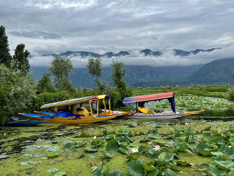 Clouds hover over Dal lake as it rains in Srinagar. (UNI)