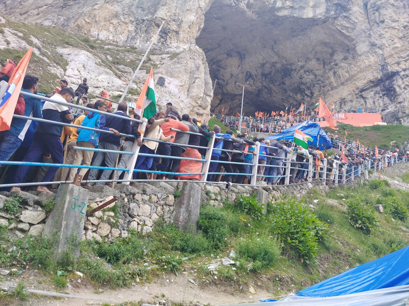 Devotees waiting in long queues for darshan at holy cave on Monday. Devotees waiting in long queues for darshan at holy cave on Monday.