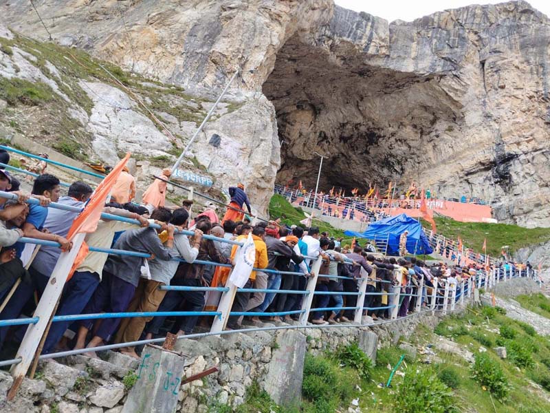 Yatris waiting in long queues at holy cave for darshan on Thursday.