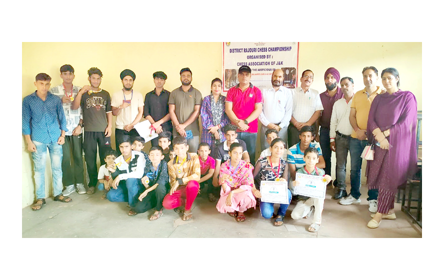 Chess players posing for a group photograph with officials during closing ceremony of District Chess Championship at Rajouri. Chess players posing for a group photograph with officials during closing ceremony of District Chess Championship at Rajouri.