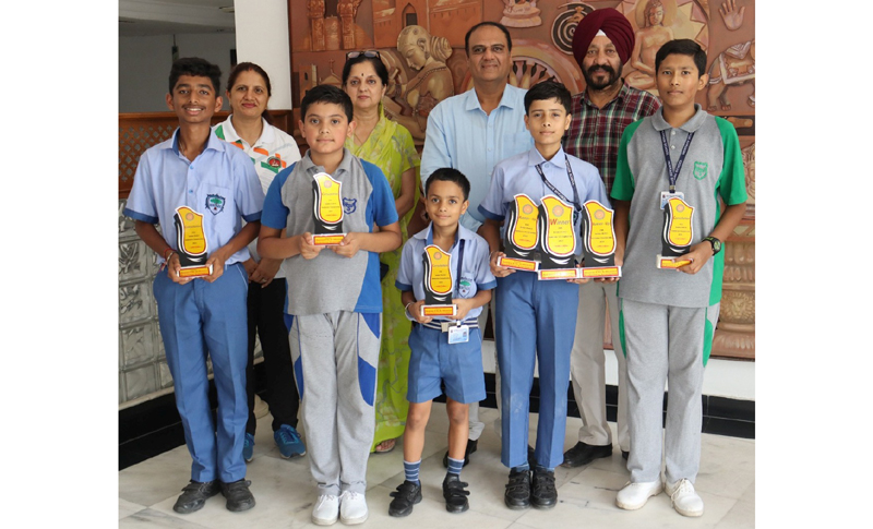 Students of Heritage School displaying trophies. Students of Heritage School displaying trophies.