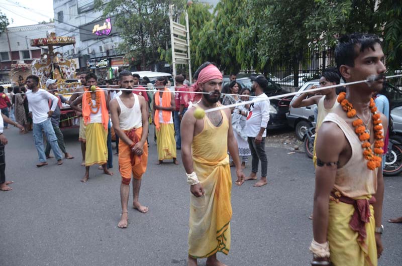 Hindu devotees with their cheeks pierced with metal rods taking part in religious procession of Sheetla Mata at Jammu on Sunday. -Excelsior/Rakesh Hindu devotees with their cheeks pierced with metal rods taking part in religious procession of Sheetla Mata at Jammu on Sunday. -Excelsior/Rakesh