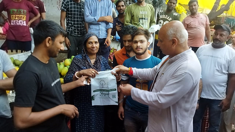 Mayor, Rajinder Sharma distributing DRDO made carry bags in a market at Jammu on Tuesday. Mayor, Rajinder Sharma distributing DRDO made carry bags in a market at Jammu on Tuesday.