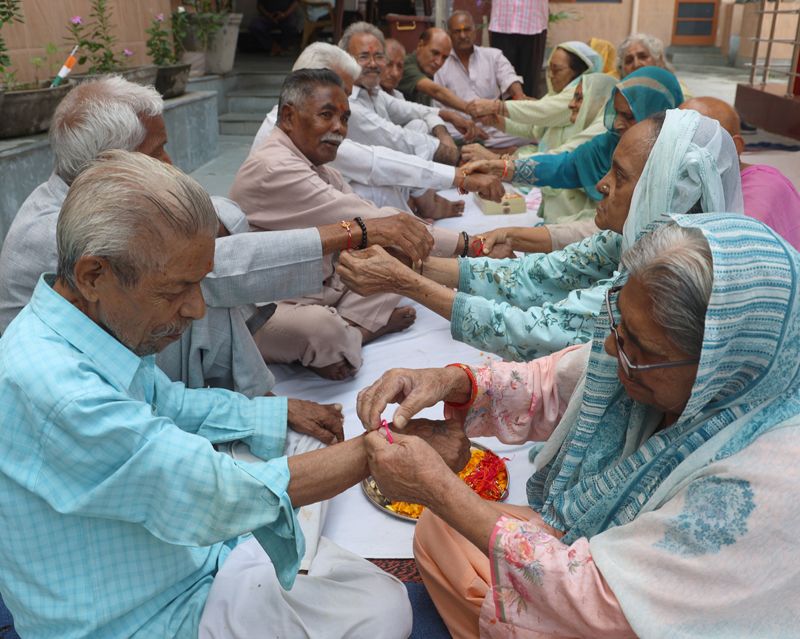 Women tying Rakhis around the wrists of male inmates in Old Age Home, Jammu on Wednesday. -Excelsior/Rakesh Women tying Rakhis around the wrists of male inmates in Old Age Home, Jammu on Wednesday. -Excelsior/Rakesh
