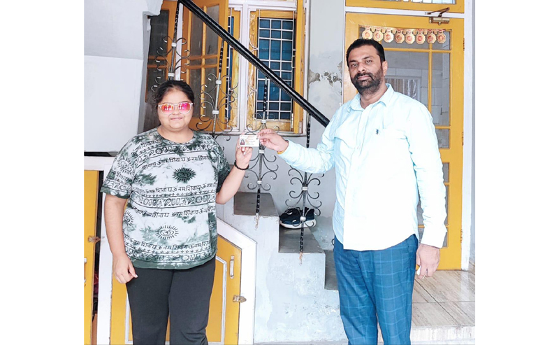Keshav Chopra handing over voter card to a newly enrolled voter. Keshav Chopra handing over voter card to a newly enrolled voter.
