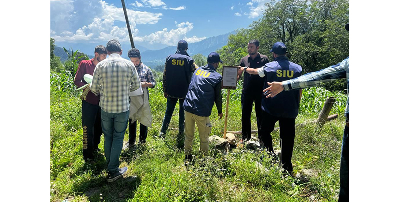 SIU team attaching property of a militant at Kralpora, Kupwara on Tuesday. SIU team attaching property of a militant at Kralpora, Kupwara on Tuesday.