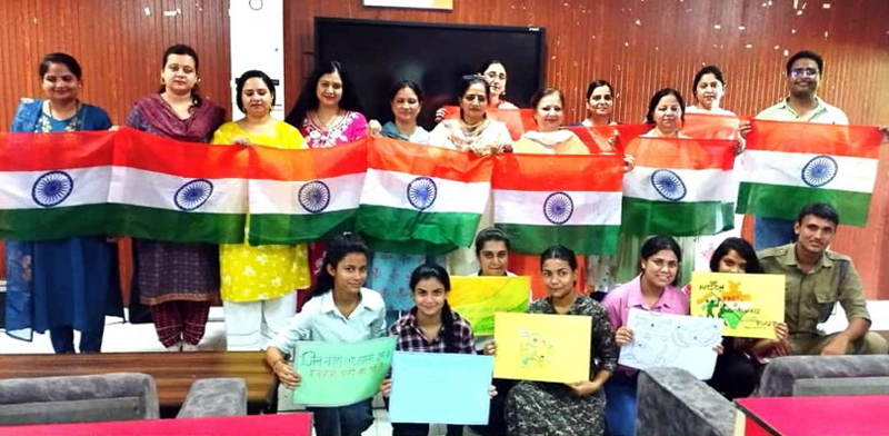 Faculty members of SPMR College and students posing along with posters and national flags. Faculty members of SPMR College and students posing along with posters and national flags.