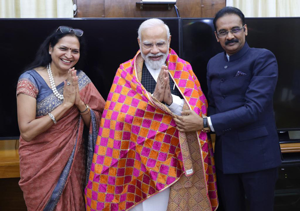 Mittal family presenting a hand-woven shawl to Prime Minister Narendra Modi in Jalandhar. Mittal family presenting a hand-woven shawl to Prime Minister Narendra Modi in Jalandhar.
