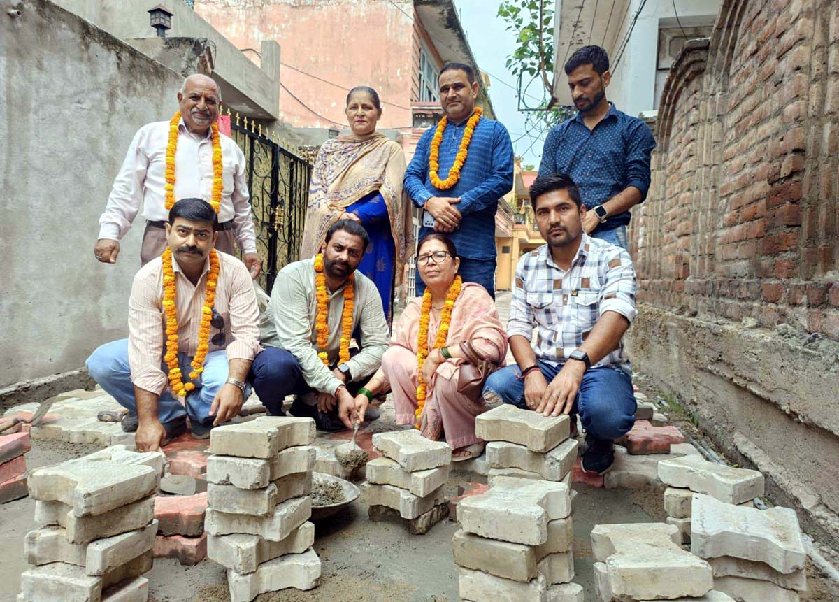 BJP councilor and other leaders kick starting laying of tile work in Bharat Nagar on Tuesday. BJP councilor and other leaders kick starting laying of tile work in Bharat Nagar on Tuesday.