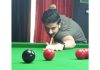 Waseem Iqbal aims at target in a Snooker match against Umer Mushtaq at Srinagar on Thursday.