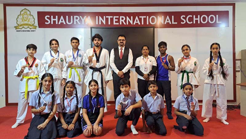 Students (Taekwondo players) of Shaurya International School posing with Principal on Monday. Students (Taekwondo players) of Shaurya International School posing with Principal on Monday.