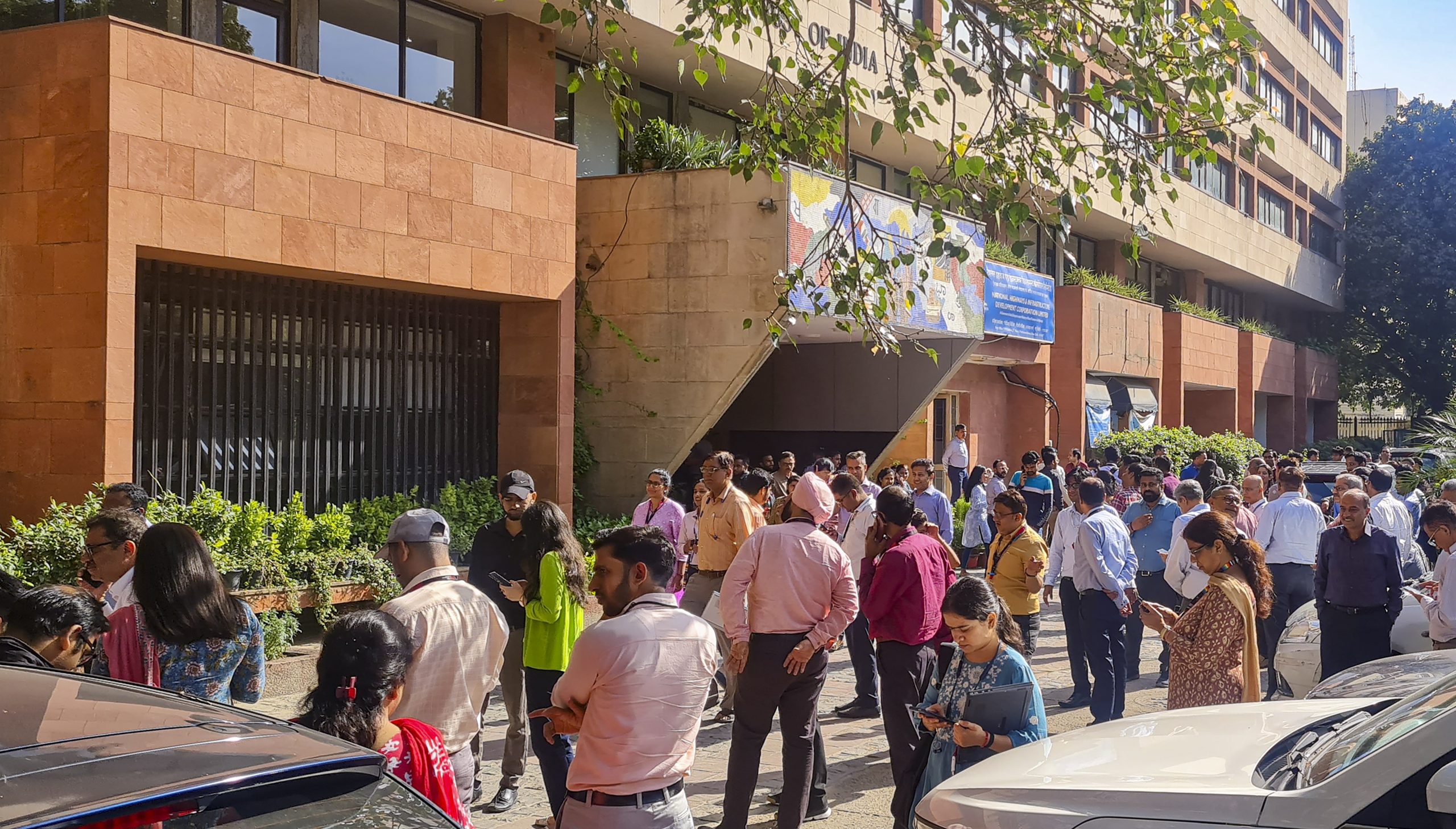 Earthquake in NCR People gather outside their offices after tremors were felt due to an earthquake, in New Delhi