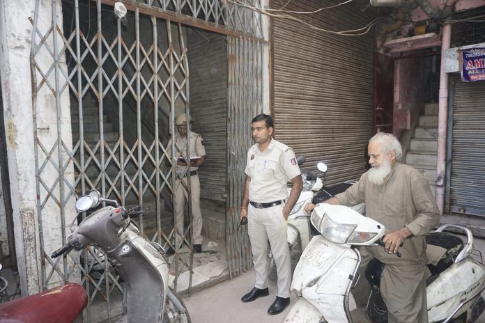NIA raids PFI premises Police personnel stand guard as the National Investigation Agency (NIA) teams raid on the premises of the banned outfit Popular Front of India (PFI), in New Delhi