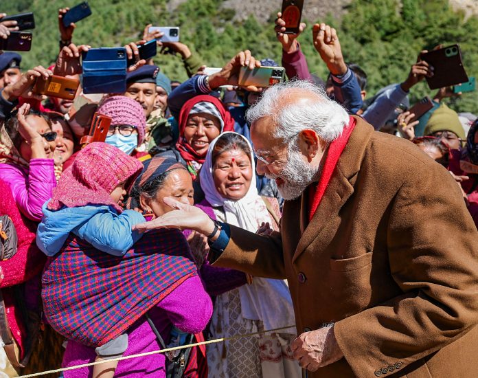 Prime Minister Narendra Modi interacts with locals at Gunji village, in Pithoragarh district