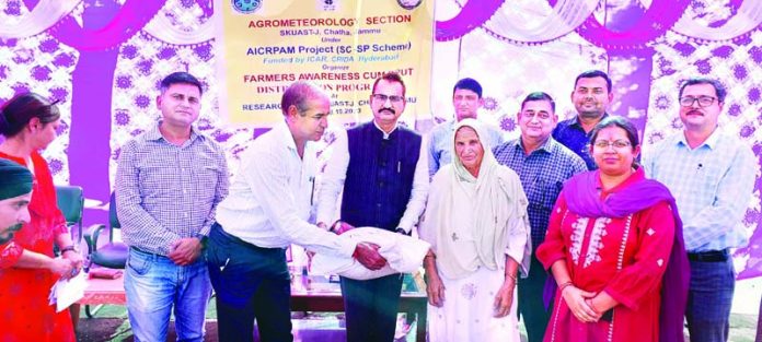 Director Research distributing high quality wheat seed during a programme at SKUAST-Jammu on Wednesday.