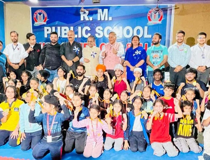 Young players posing with dignitaries during Kickboxing Championship on Saturday.