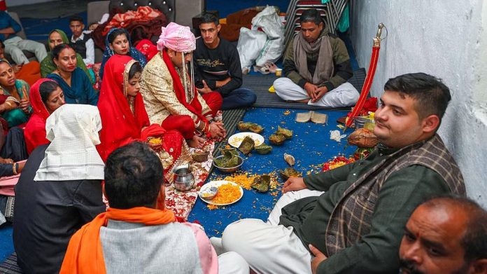 WEDDING People during a marriage ceremony at a community centre, even as Pakistan Rangers fired without provocation along the international border in Arnia sector of Jammu & Kashmir.