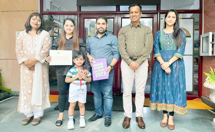A four-year-old Zorica posing with parents and school management.