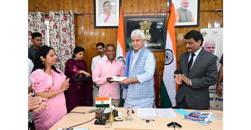 LG Manoj Sinha handing over land allotment letter to a beneficiary in Srinagar on Monday. LG Manoj Sinha handing over land allotment letter to a beneficiary in Srinagar on Monday.