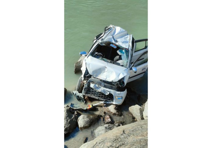 Mingled remains of a car that fell in r iver Chenab at Kishtwar on Friday. —Excelsior/Tilak Raj