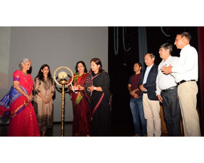 Guest speakers lighting ceremonial lamp during awareness programme at SMVDU.