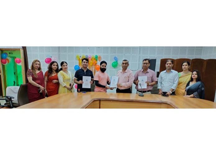 Principal of Govt Polytechnic for Woman, Jammu and others displaying copies of MoU signed with M/s Ecoepicsolar Pvt Ltd Jammu.