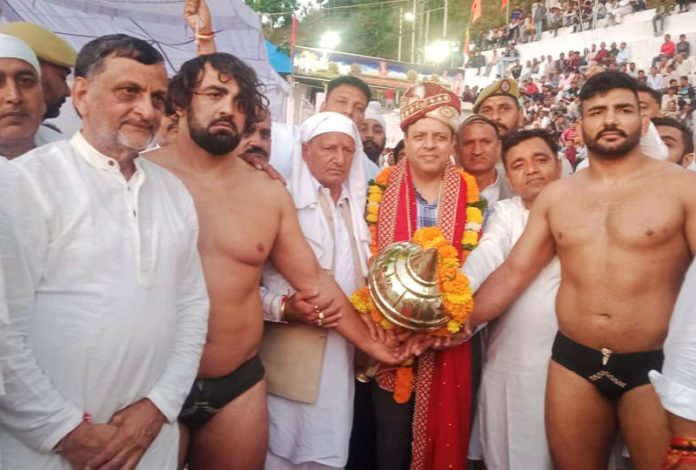 Commissioner Secretary GAD, Sanjeev Verma introducing wrestlers before match at Mathwar.