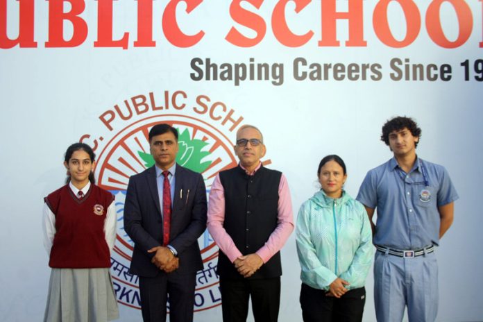 KCPS swimmers posing with the School Chairman, Principal and their coach.