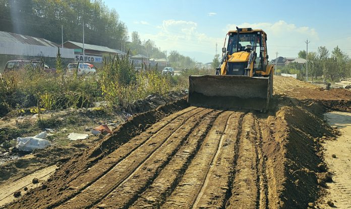 Work apace on the 4-laning of Srinagar-Baramulla National Highway near Sangrama on Saturday. -Excelsior/Aabid Nabi
