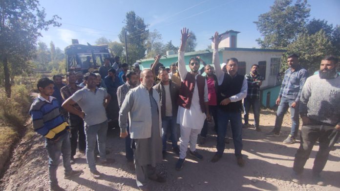 Taxi drivers and locals protesting for completion of blacktopping work on Mendhar road.