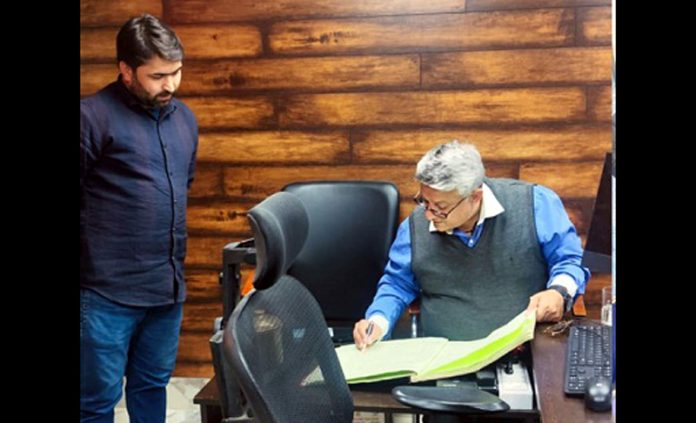 DC Doda inspecting record of an office during surprise visit.