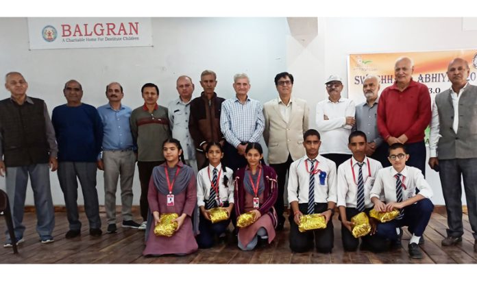 Members of CGPWA and BALGRAN posing for a group photograph with children during a function at Jammu on Saturday.