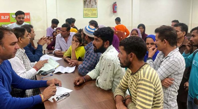 Former Minister, Sat Sharma listening public grievances at Jammu on Wednesday.