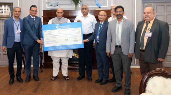 BEL CMD Bhanu Prakash Srivastava presenting a cheque of Rs 224.28 crore to Defence Minister Rajnath Singh at New Delhi.