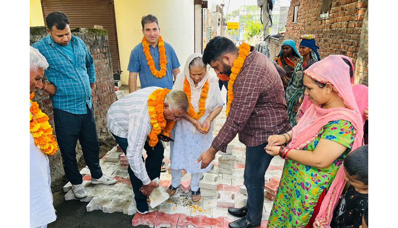Former Minister and senior BJP leader Ch Sukhnandan and corporator, Ward 64, Kapil Chib starting construction of lanes and drains in Ward 64 on Monday. Former Minister and senior BJP leader Ch Sukhnandan and corporator, Ward 64, Kapil Chib starting construction of lanes and drains in Ward 64 on Monday.