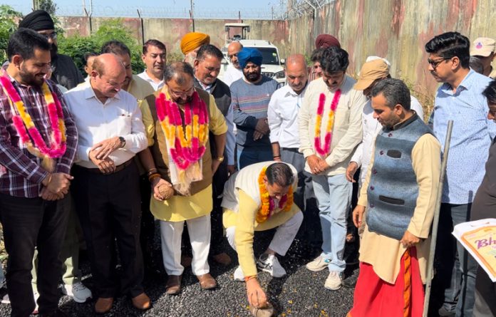 Dy Mayor, Baldev Singh Billawaria and former MLC, Vikram Randhawa kick starting blacktopping of road near Jammu Airport on Friday.