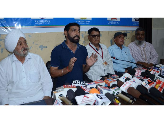 Members of ex-CPMFWA addressing a press conference in Jammu on Friday.