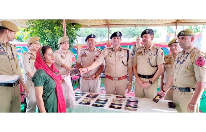 SSP Samba, Benam Tosh handing over recovered Smart phones to their owners at Samba on Wednesday.