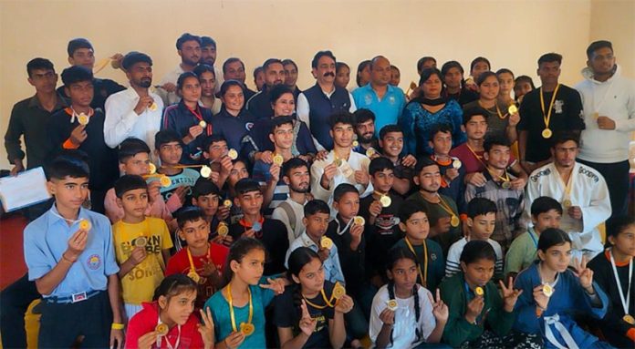 Judokas posing with medals during an event at Kathua on Saturday.